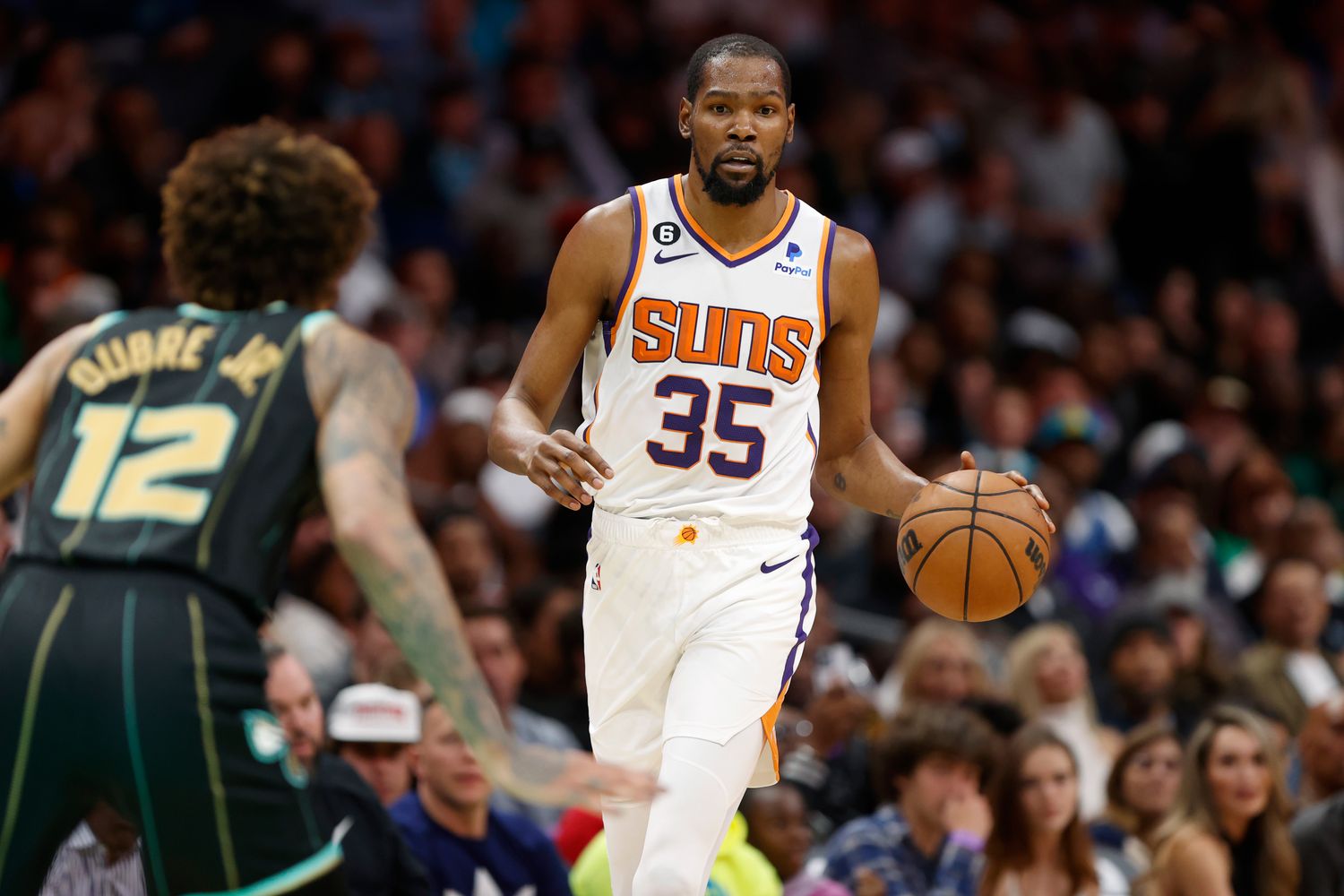 Charlotte Hornets forward Kelly Oubre Jr. defends Phoenix Suns forward Kevin Durant.